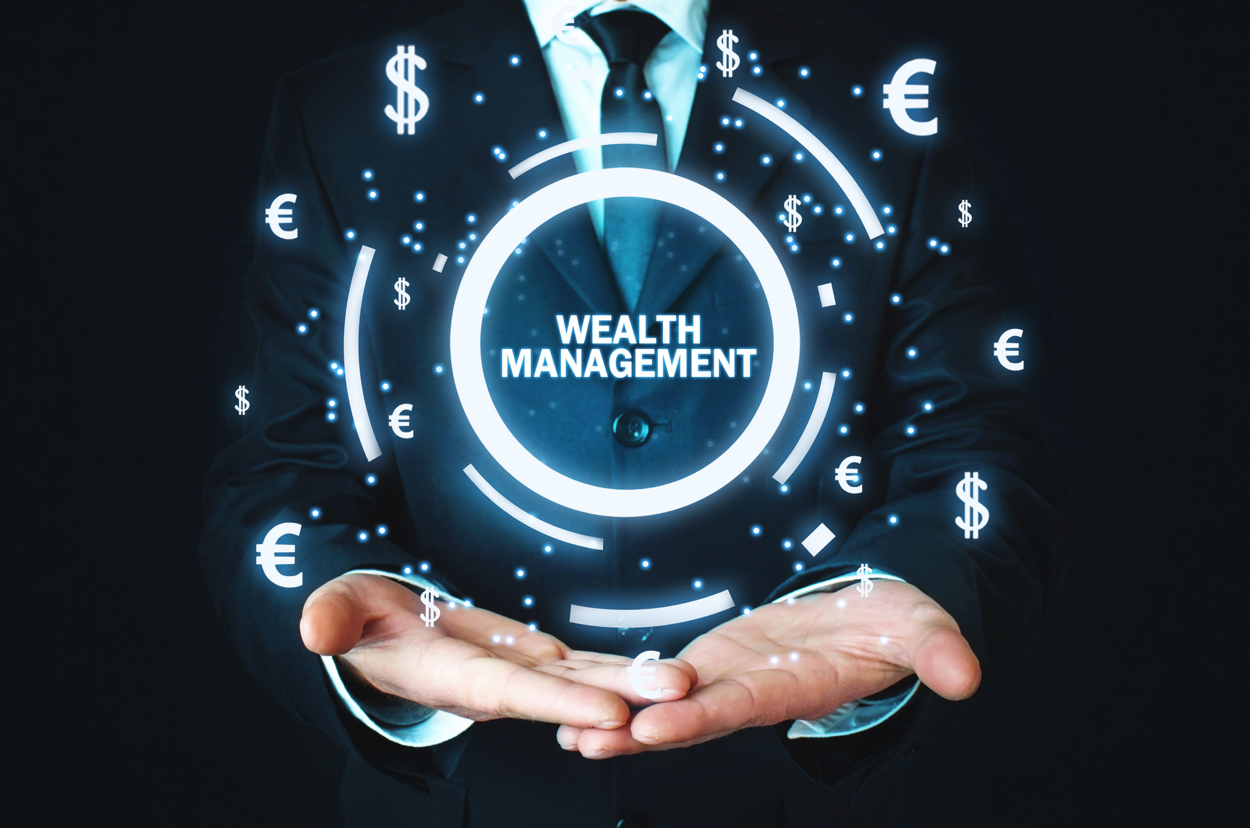 Businessman holding Wealth Management word with currency symbols